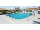 Large, inviting community pool with a glimpse of surrounding landscaping and buildings at 7245 Wood Creek Dr # 29, Sarasota, FL 34231