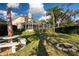 Backyard with lush green lawn, fire pit, and screened-in lanai at 732 June Lake Ln, Brandon, FL 33510
