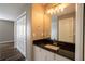 Bathroom featuring a vanity with granite countertop, closet space, and ample lighting for a functional and stylish space at 732 June Lake Ln, Brandon, FL 33510