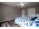 Bright bedroom with hardwood floors, a modern ceiling fan, and double door closets at 732 June Lake Ln, Brandon, FL 33510