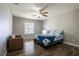 Bedroom with modern ceiling fan, hardwood floors, and large window, creating an open, inviting space at 732 June Lake Ln, Brandon, FL 33510