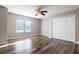 Bedroom features wood floors, ample natural light, and a spacious closet, combining comfort and functionality at 732 June Lake Ln, Brandon, FL 33510