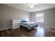 This bedroom features wood floors, a ceiling fan and a window allowing for plenty of natural light at 732 June Lake Ln, Brandon, FL 33510