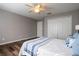 Bedroom with wood floors features closet space and bright lighting for a peaceful and organized retreat at 732 June Lake Ln, Brandon, FL 33510