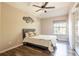 Cozy bedroom with wood-look flooring, ceiling fan, and a sliding glass door to the outside at 732 June Lake Ln, Brandon, FL 33510