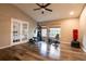 Large bonus room with wood floors and exercise equipment offers versatile space for fitness and recreation at 732 June Lake Ln, Brandon, FL 33510