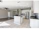 Bright kitchen features white cabinets, stainless steel appliances, and a functional center island at 732 June Lake Ln, Brandon, FL 33510