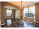 Inviting living area featuring hardwood floors, large windows, and elegant sheer curtains at 732 June Lake Ln, Brandon, FL 33510