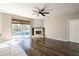 Bright living room features a stone fireplace, hardwood floors, and sliding glass doors to the pool at 732 June Lake Ln, Brandon, FL 33510