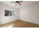 Bedroom features wood-look flooring, a ceiling fan and a single window at 810 E Baker St, Tampa, FL 33603