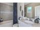 Elegant bathroom with a marble countertop, tiled shower, and neutral color scheme for a spa-like feel at 8621 Snowfall St, Sarasota, FL 34241
