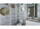 Chic powder room featuring patterned wallpaper, granite countertop, and decorative fixtures at 8621 Snowfall St, Sarasota, FL 34241