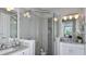 Stylish bathroom featuring a glass-enclosed shower, granite countertops, and dual sinks at 8621 Snowfall St, Sarasota, FL 34241