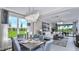 Elegant dining area flowing into the living room with backyard views and stylish chandelier at 8621 Snowfall St, Sarasota, FL 34241