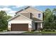 Charming two-story home with stone accents, a two-car garage, and inviting curb appeal at 8621 Snowfall St, Sarasota, FL 34241