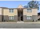 Exterior view of a two-story condo building with a center peaked entry featuring a mix of brick and stucco at 9007 Westchester Cir # 14, Tampa, FL 33604