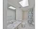 Bright bathroom featuring a vanity and shower with a tropical-themed curtain at 1028 Apollo Beach Blvd # 13, Apollo Beach, FL 33572