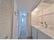 Hallway with laundry closet including a white washer and dryer at 1028 Apollo Beach Blvd # 13, Apollo Beach, FL 33572