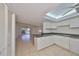 Bright kitchen features white cabinets, skylight, and seamless access to living area at 1028 Apollo Beach Blvd # 13, Apollo Beach, FL 33572