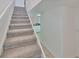 Bright staircase with plush carpeting leads to the upper level of this modern home at 1028 Apollo Beach Blvd # 13, Apollo Beach, FL 33572