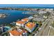 Stunning aerial view of waterfront condos with boat docks, city skyline, and a bright blue ocean backdrop at 1030 Bellasol Way # 302, Apollo Beach, FL 33572