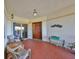 Inviting covered balcony entrance with ample seating and tiled flooring, perfect for relaxation and greeting guests at 1030 Bellasol Way # 302, Apollo Beach, FL 33572