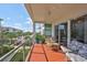 Spacious balcony with ample seating and views of lush landscaping, a pool, and a clear blue sky at 1030 Bellasol Way # 302, Apollo Beach, FL 33572