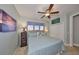 Comfortable bedroom featuring neutral walls, a ceiling fan, and a plush bed with decorative pillows at 1030 Bellasol Way # 302, Apollo Beach, FL 33572