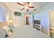 Bright bedroom offering a ceiling fan, natural light, with a closet and tiled floors at 1030 Bellasol Way # 302, Apollo Beach, FL 33572
