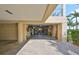 Large garage space with ample room for parking and storage, plus an open door to storage room in the rear at 1030 Bellasol Way # 302, Apollo Beach, FL 33572