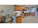 Open-concept kitchen with breakfast bar, stainless steel appliances, and light wood cabinets at 1030 Bellasol Way # 302, Apollo Beach, FL 33572