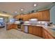 Well-lit kitchen with stainless steel appliances, light wood cabinets, and stone countertops at 1030 Bellasol Way # 302, Apollo Beach, FL 33572