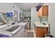 Functional laundry room with washer, dryer, utility sink, and storage cabinets with tiled flooring at 1030 Bellasol Way # 302, Apollo Beach, FL 33572