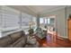 Cozy living room corner with a comfortable armchair, bright window, and sliding door leading to the balcony at 1030 Bellasol Way # 302, Apollo Beach, FL 33572