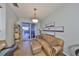 Comfortable living room with a leather couch, balcony access, and nautical themed decorations at 1030 Bellasol Way # 302, Apollo Beach, FL 33572