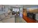 Relaxing living room with plush seating, a fireplace, hardwood floors, and a large window for natural light at 1030 Bellasol Way # 302, Apollo Beach, FL 33572