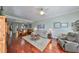 Spacious living room with hardwood floors and an open layout connecting to the dining area and kitchen at 1030 Bellasol Way # 302, Apollo Beach, FL 33572