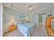 Cozy main bedroom with carpet, tray ceiling, and a large window with plenty of light at 1030 Bellasol Way # 302, Apollo Beach, FL 33572
