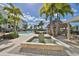 Water fountain near the community pool and tiki bar, surrounded by tropical plants and providing a gathering place at 1030 Bellasol Way # 302, Apollo Beach, FL 33572