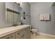 Stylish bathroom featuring gray vanity, modern fixtures, and white honeycomb tile flooring at 10764 70Th Ave # 2110, Seminole, FL 33772