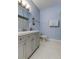 Charming bathroom with a gray vanity, modern fixtures, and white honeycomb tile flooring at 10764 70Th Ave # 2110, Seminole, FL 33772
