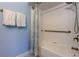 Clean bathroom with a shower-tub combo, featuring white tile and a stylish shower curtain at 10764 70Th Ave # 2110, Seminole, FL 33772