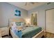 Bedroom with comfortable bed, ensuite bath, and wood flooring at 10764 70Th Ave # 2110, Seminole, FL 33772