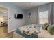 Bright bedroom with blue walls, TV, and modern decor at 10764 70Th Ave # 2110, Seminole, FL 33772