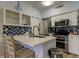 Bright kitchen with stainless steel appliances, a center island and a blue tile backsplash at 10764 70Th Ave # 2110, Seminole, FL 33772