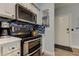 Kitchen with stainless oven and range, microwave, knife block, toaster and white cabinets at 10764 70Th Ave # 2110, Seminole, FL 33772