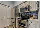 Kitchen with stainless appliances including double oven and white cabinets at 10764 70Th Ave # 2110, Seminole, FL 33772