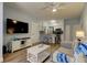 Open-concept living room with a view into the kitchen and modern furniture at 10764 70Th Ave # 2110, Seminole, FL 33772