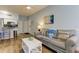 Living room with couch, artwork, and view into the kitchen at 10764 70Th Ave # 2110, Seminole, FL 33772
