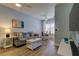 Bright living room features a sofa, ceiling fan, a coffee table and wood flooring at 10764 70Th Ave # 2110, Seminole, FL 33772